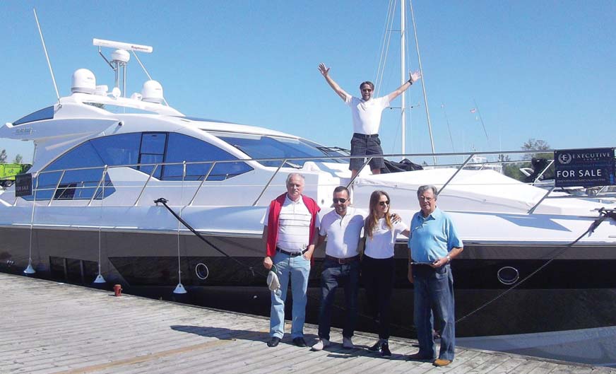 The Executive Yacht Canada team celebrates a new arrival earlier this spring.