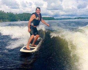 Ron wake surfing behind a friends boat in Muskoka, Ontario.