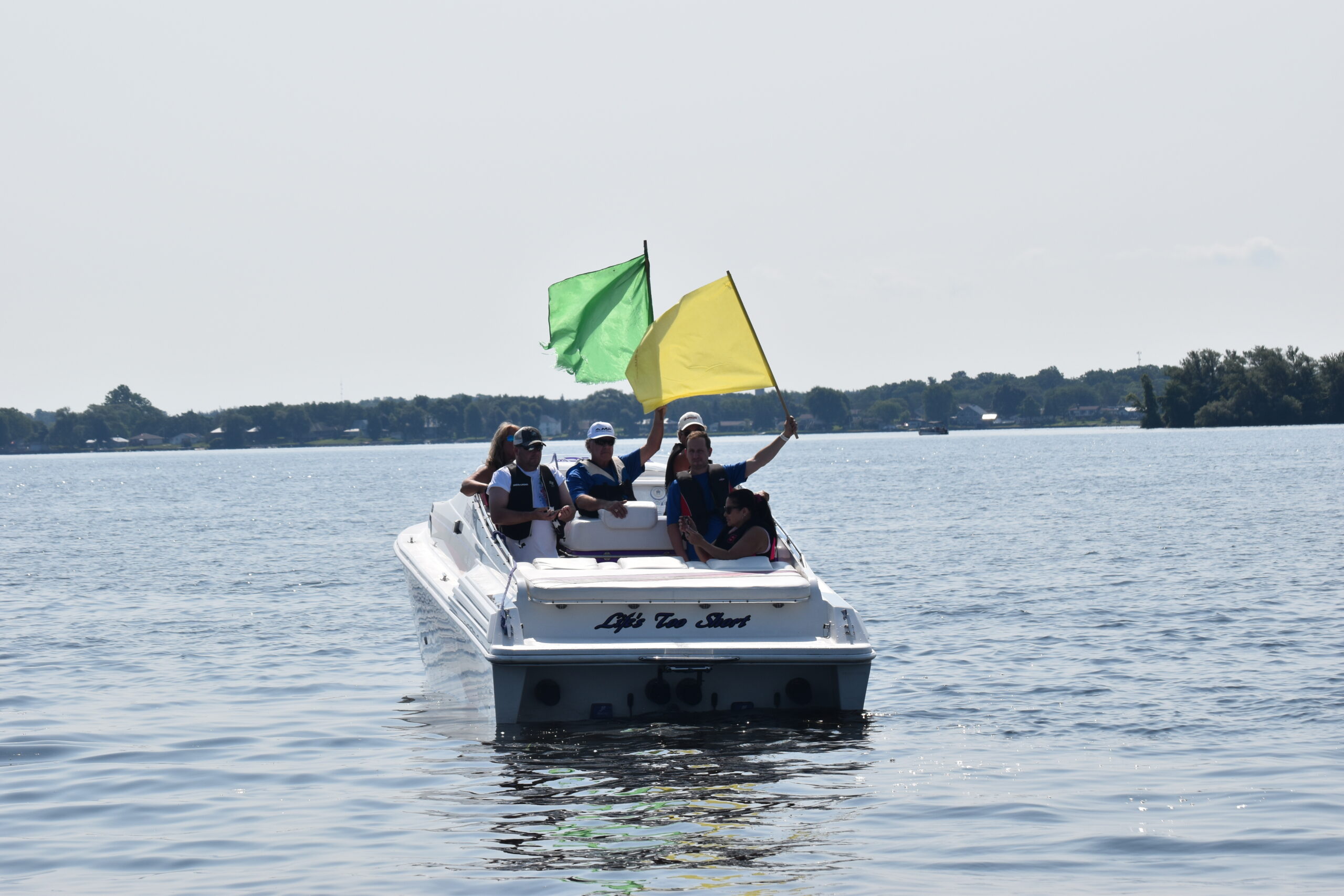 Poker Runs America Founder, Bill Taylor, holding up the green flag signalling the start of the Poker Run.