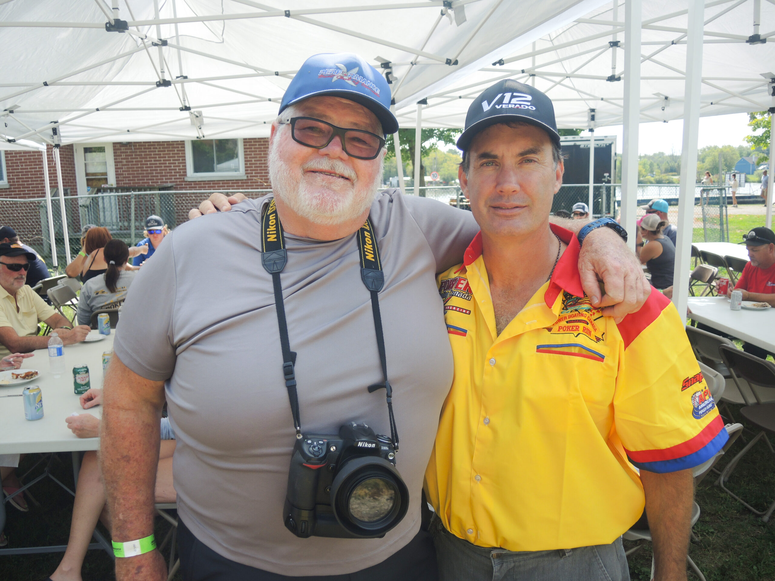 Carl McBride, Todd Taylor, and fellow Poker Runners take a well-deserved lunch break at the RiceLake Poker Run, savouring good food and great company.